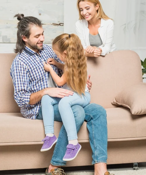 girl-buttoning-her-father-s-shirt